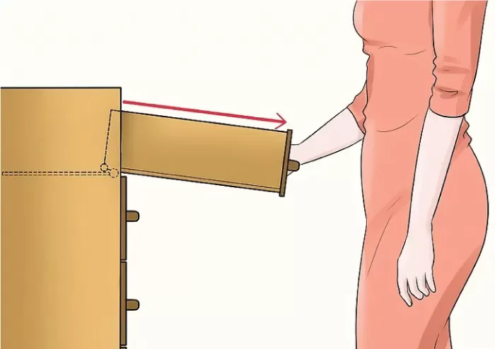 Nghiêng ngăn kéo tủ xuống để tháo ray bánh xe